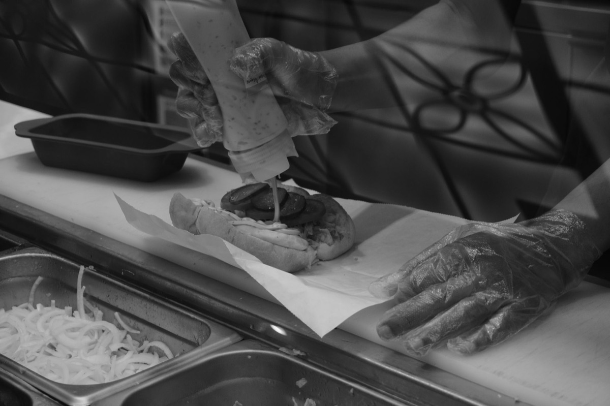 Cuban sandwich preparation on wooden board