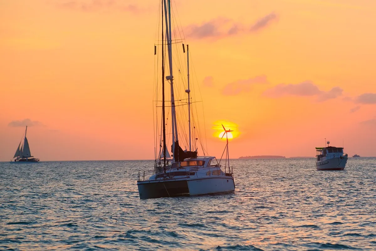 key west, florida, sunset, boats, ocean, scenic, tropical paradise, coastal beauty, waterfront, golden hour, maritime, sunset colors, island life, tranquil sea,