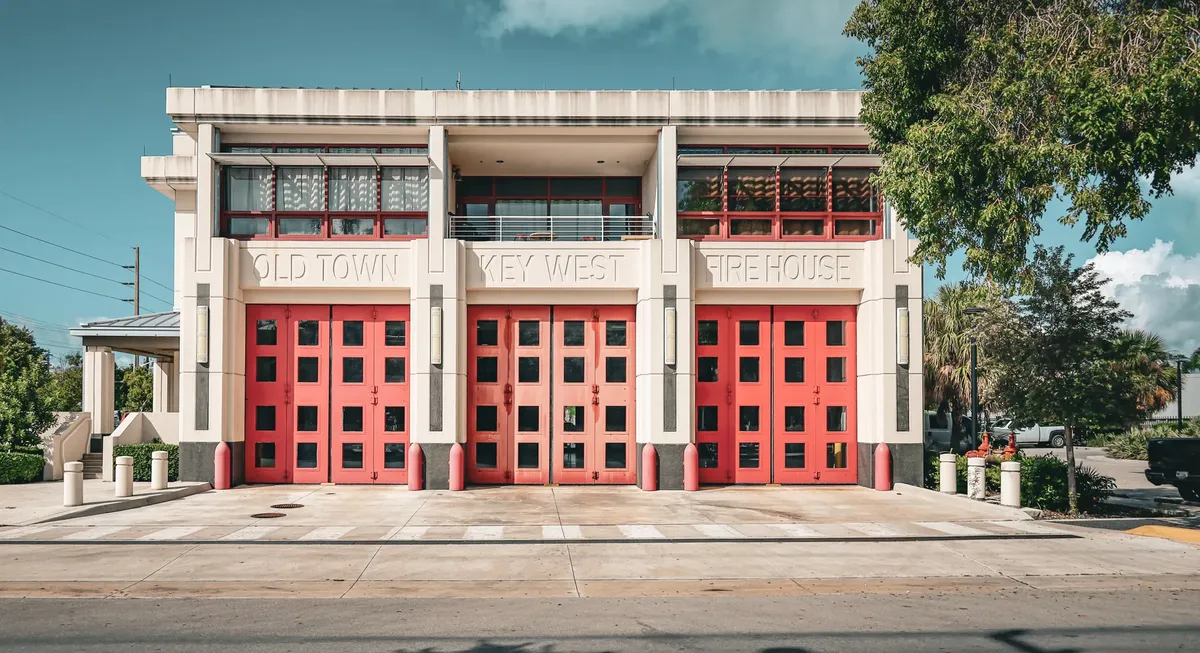 Front view of the Old Town Key West Firehouse featuring iconic red doors.